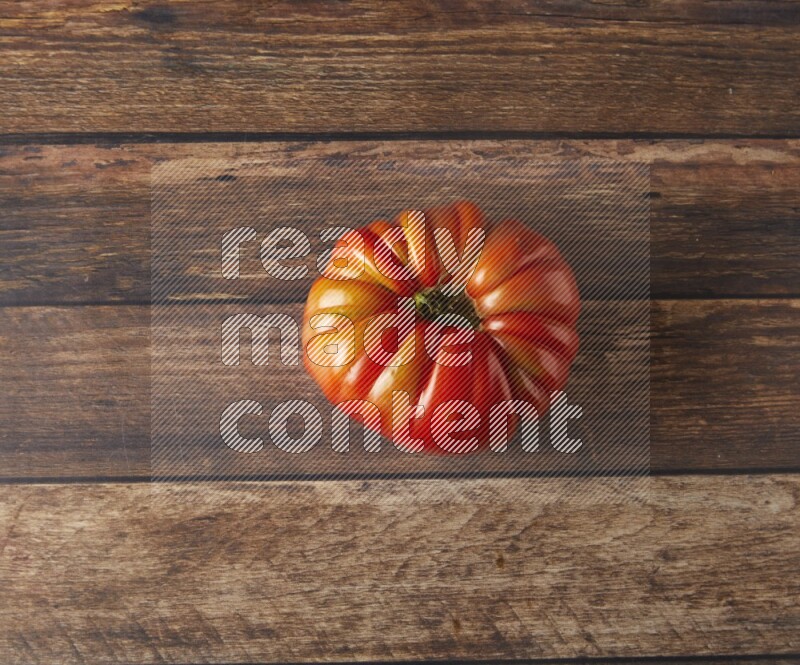 Single topview Heiloom Tomato on a wooden background