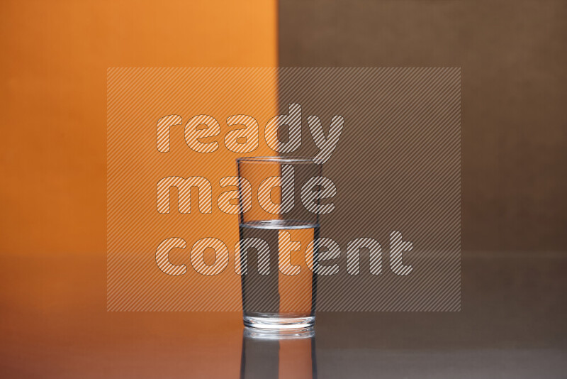 The image features a clear glassware filled with water, set against orange and brown background