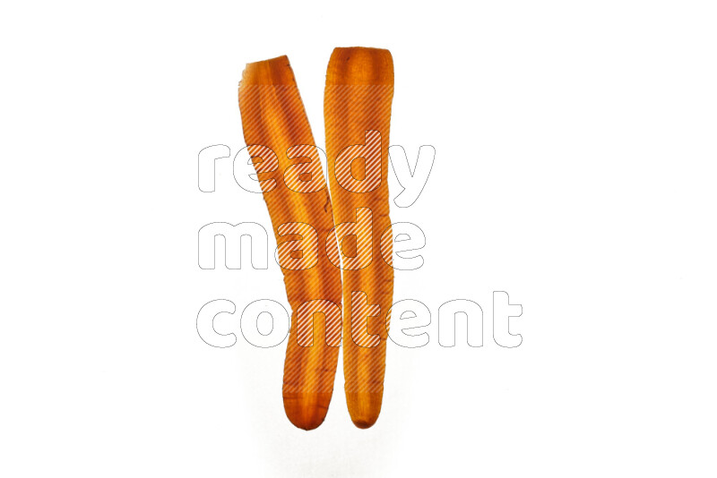 Carrots slices on illuminated white background
