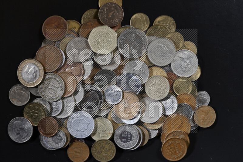 A close-ups of random old coins on black background