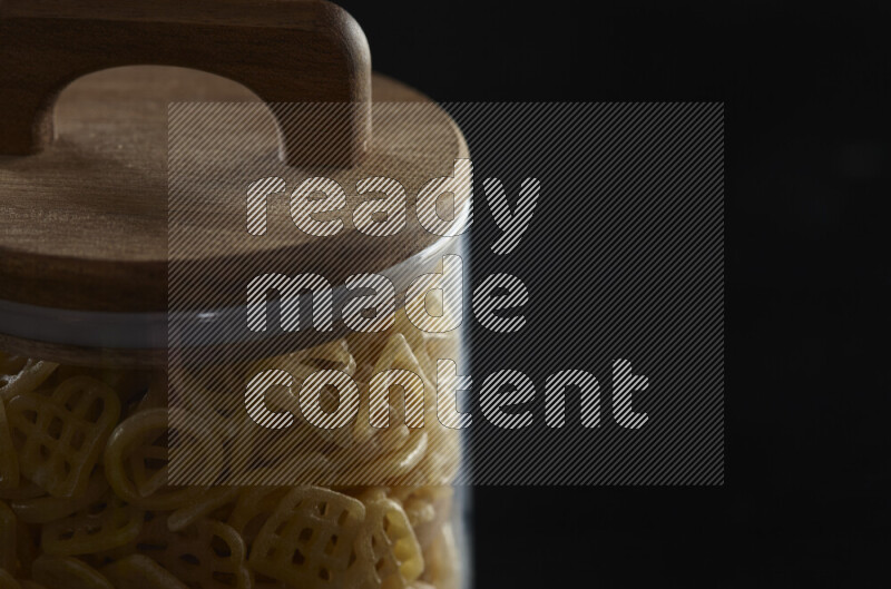 Snacks in a glass jar on black background