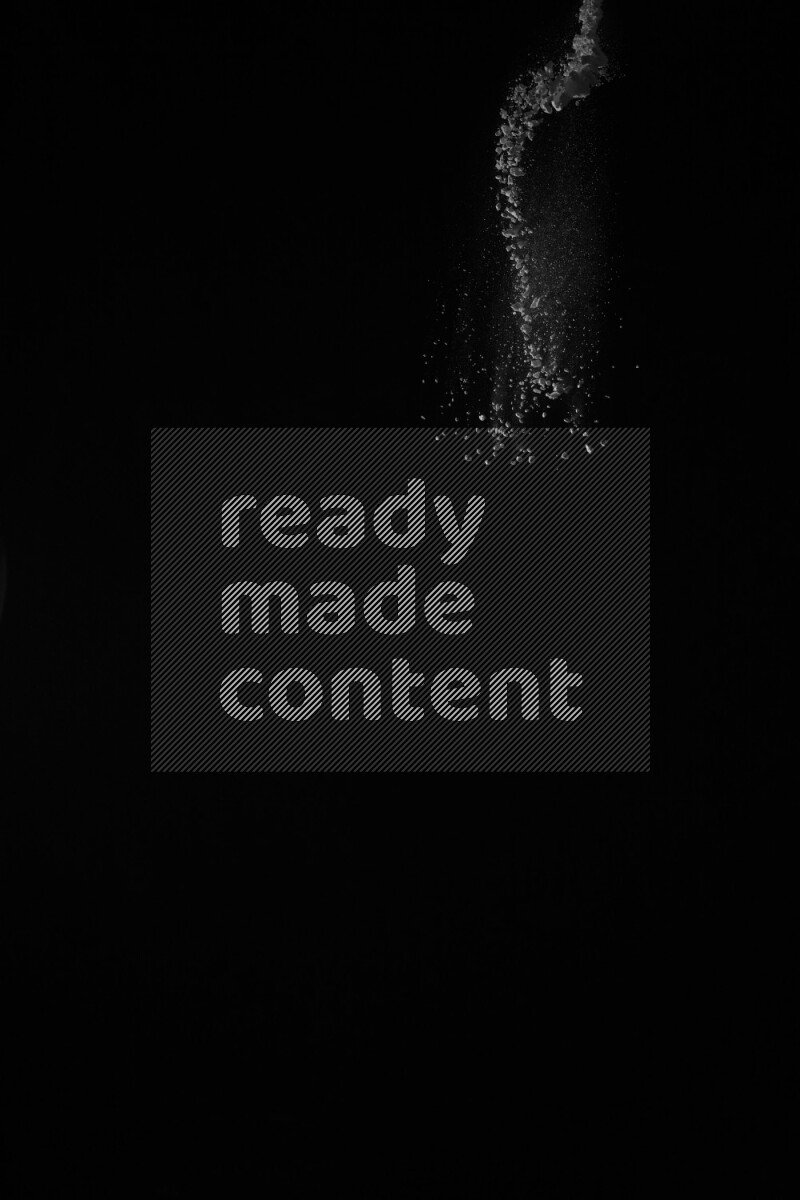 A side view of white powder explosion on black background