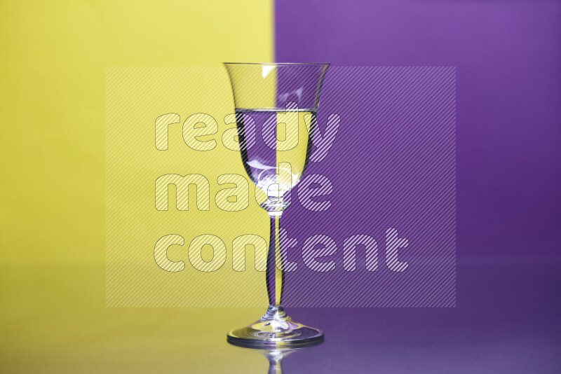 The image features a clear glassware filled with water, set against yellow and purple background