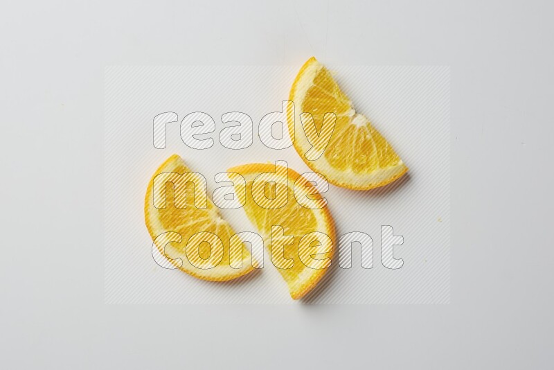 Three halves of an orange slices on white background