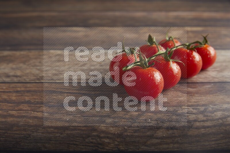 Red cherry tomato vein on a textured wooden background 45 degree