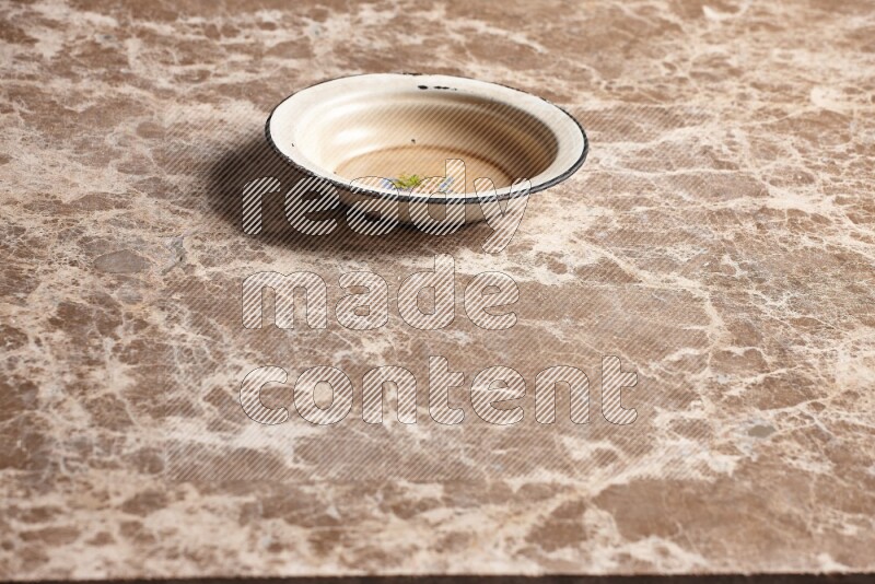 A vintage metal plate on beige marble background