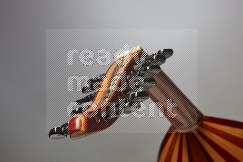 parts of a brown wooden Oud in a gray background