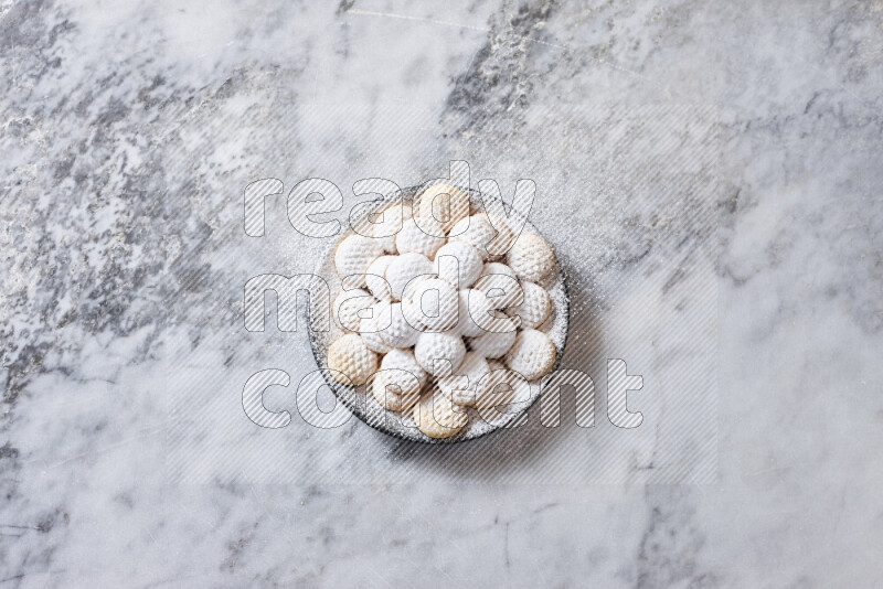 Kahk in black pottery plate on grey marble background