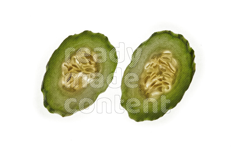 Cucumber slices on illuminated white background