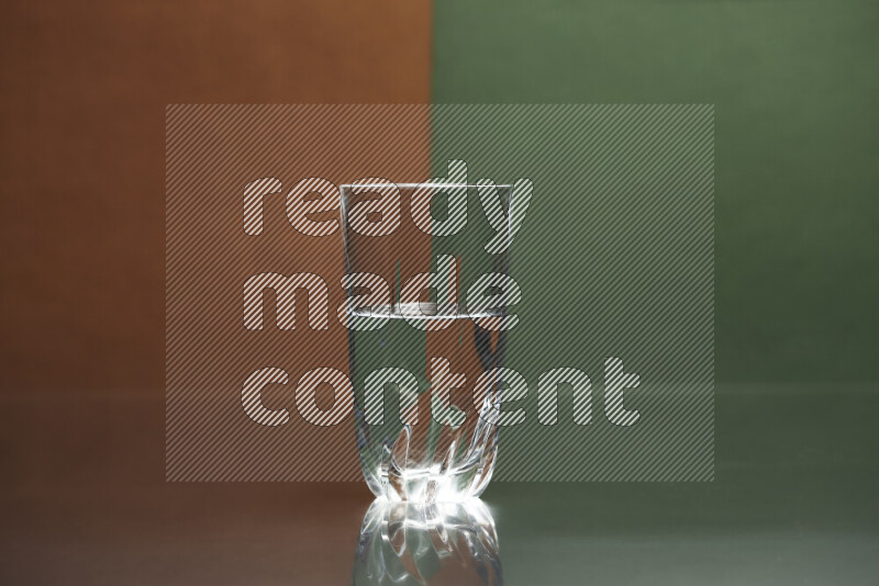 The image features a clear glassware filled with water, set against brown and dark green background