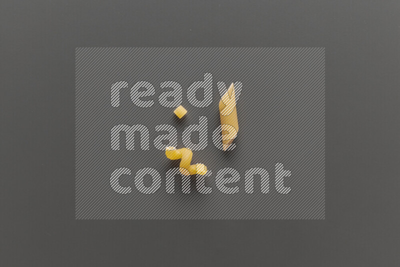 Different pasta types on grey background