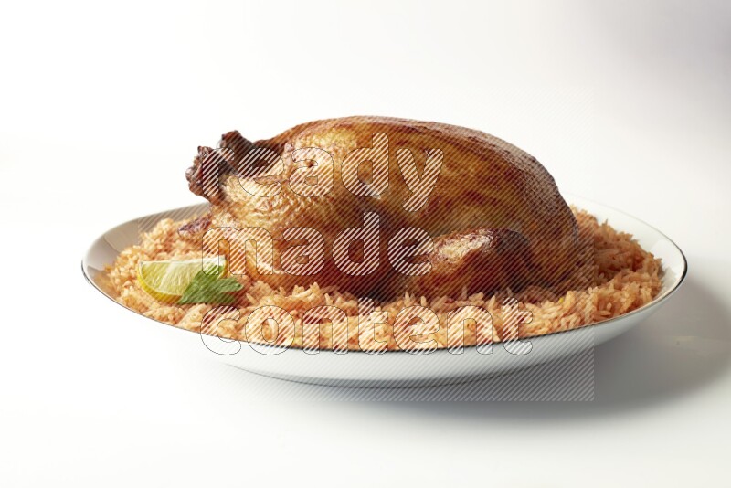 red basmati Rice with whole roasted chicken on a white plate with a silver rim direct on white background