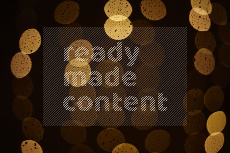 Bokeh light in yellow with water drops