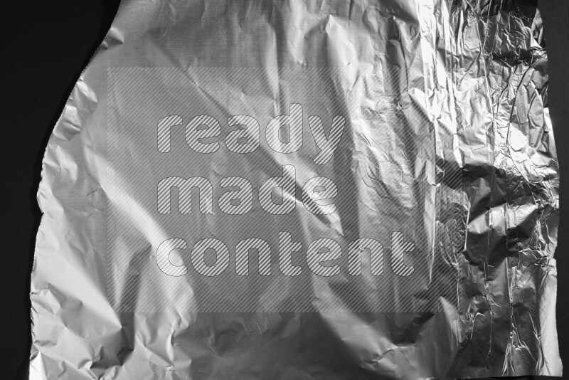 Aluminium foil on black background