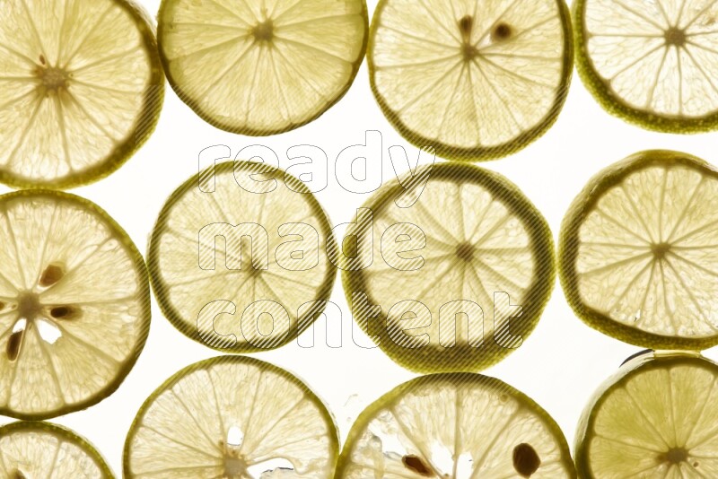 Lemon slices on illuminated white background