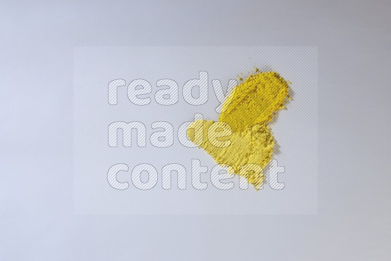 Yellow powder smears on white background