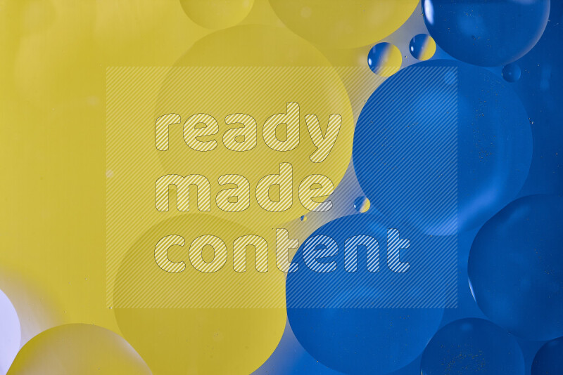 Close-ups of abstract oil bubbles on water surface in shades of blue and yellow