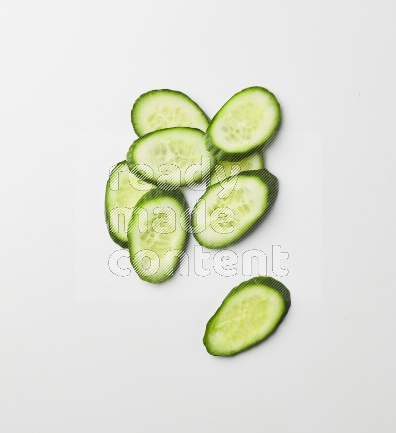 Multiple cucumber slices on white background