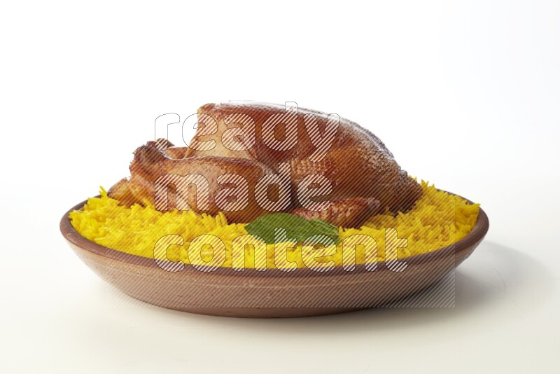 yellow basmati Rice with whole roasted chicken  on a pottery plate  direct  on white background