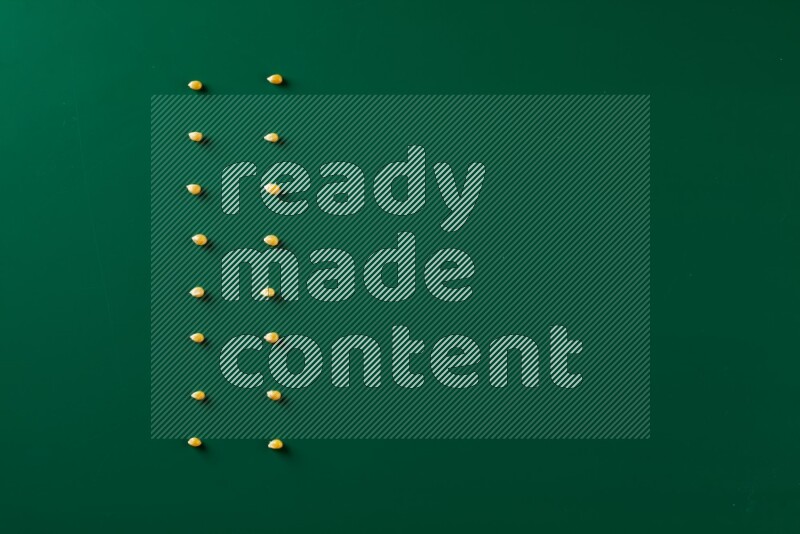 Popcorn seeds on a green background in a top view shot