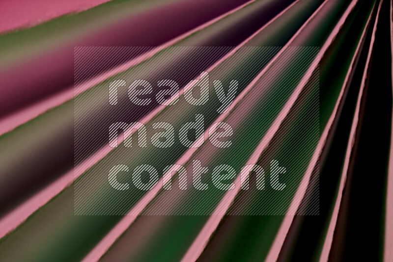 An image presenting an abstract paper pattern of lines in green and pink tones