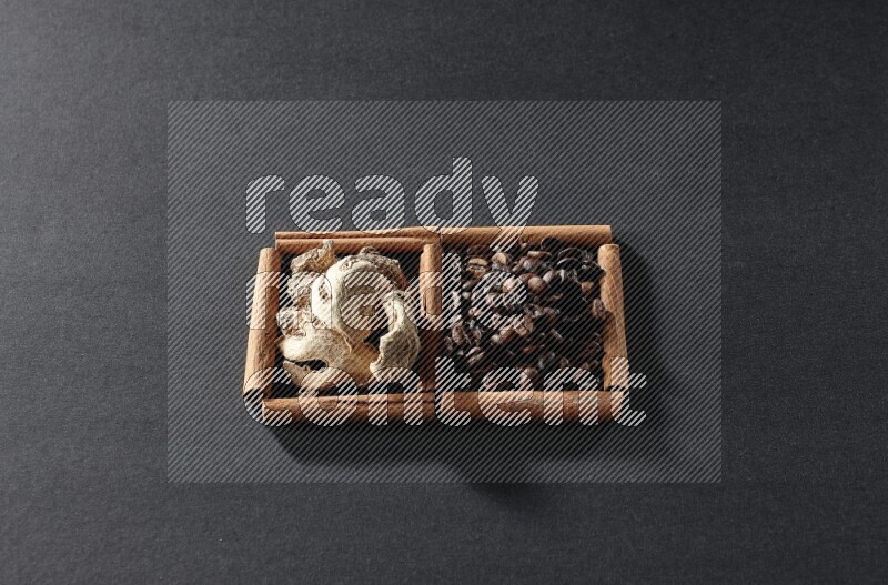 2 squares of cinnamon sticks full of coffee beans and ginger on black flooring