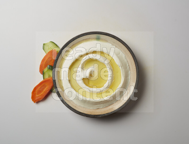 Lebnah garnished with olive oil in a pottery plate on a white background