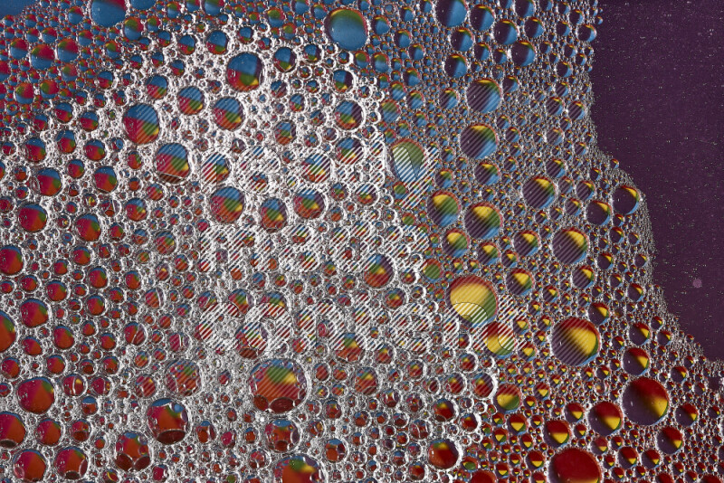 Close-ups of abstract soap bubbles and water droplets on multicolored background
