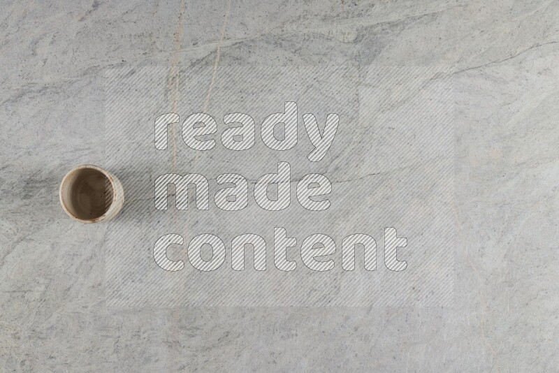 A multicolored pottery Cup on grey marble background