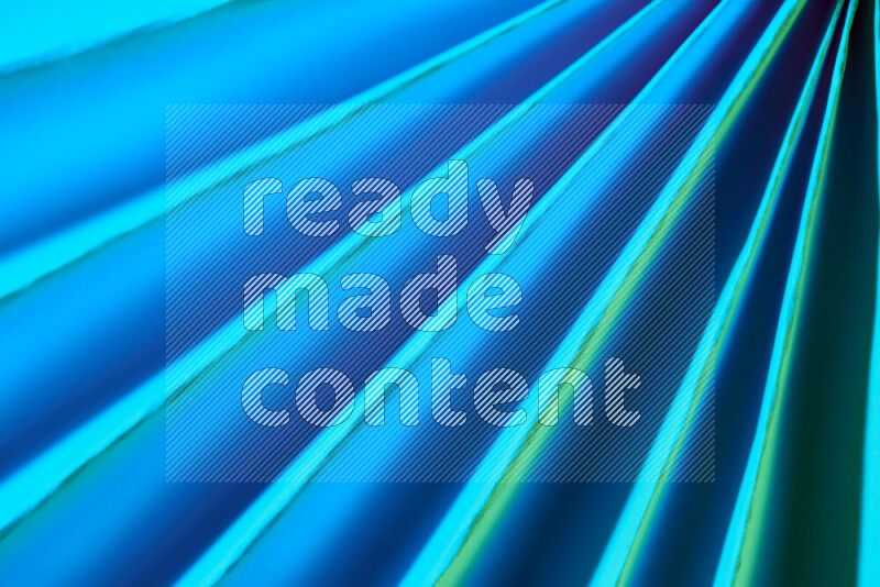 An image presenting an abstract paper pattern of lines in green and blue tones