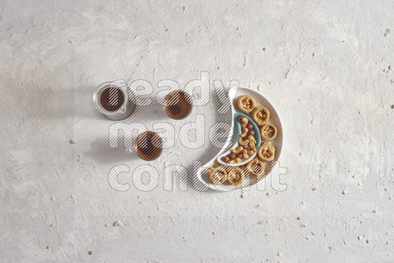Oriental sweets in a pottery plate with drinks in a light setup
