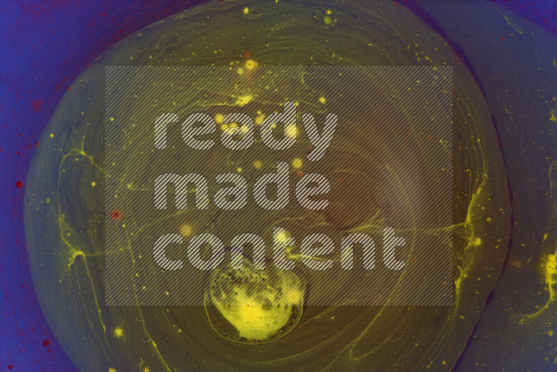 The image captures a dramatic splatter of yellow and red paints over an blue backdrop