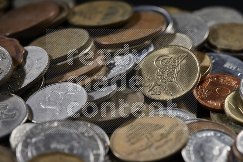 A close-ups of random old coins on black background
