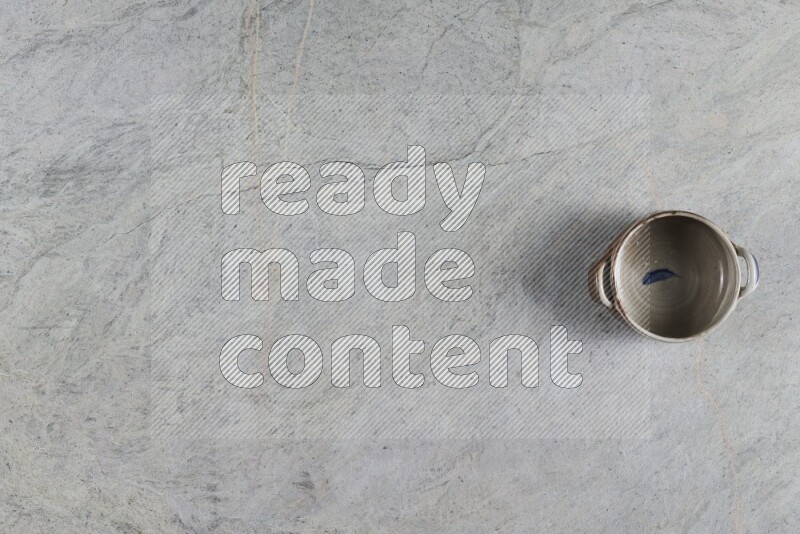 A multicolored pottery Bowl on grey marble background