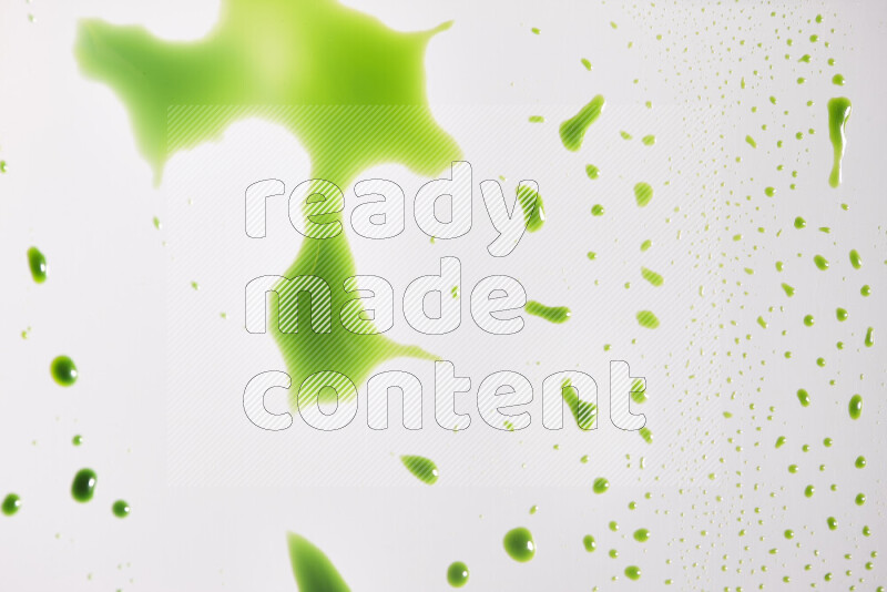 Close-ups of abstract green paint droplets on the surface