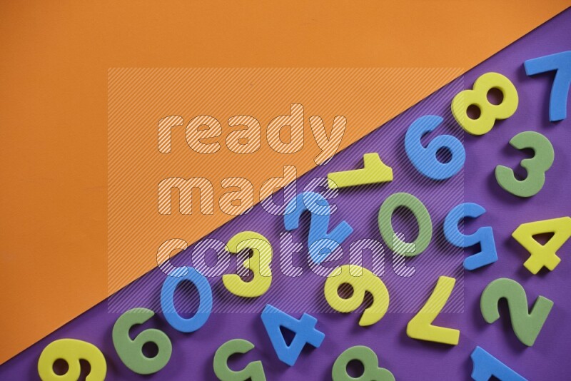 Colorful foam numbers for kids on orange and purple background (kids toys)