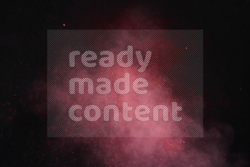 Red powder explosion on black background