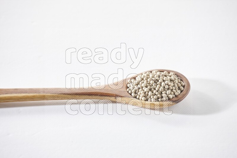 White pepper in a ladle