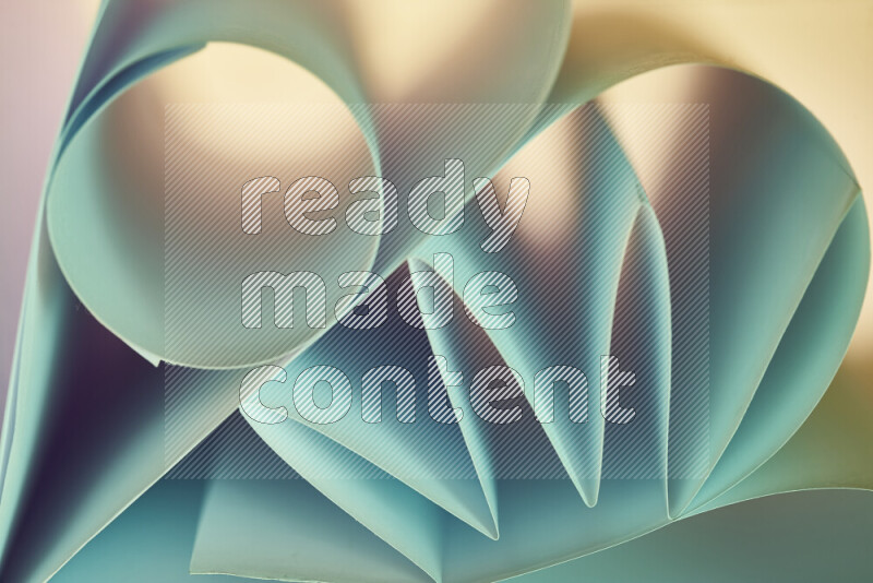 An artistic display of paper folds creating a harmonious blend of geometric shapes, highlighted by soft lighting in green and warm tones