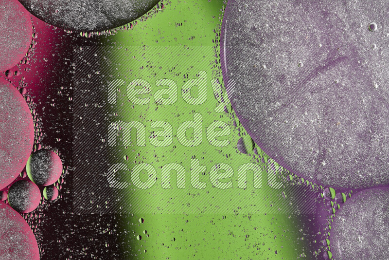 Close-ups of abstract oil bubbles on water surface in shades of green, purple and pink