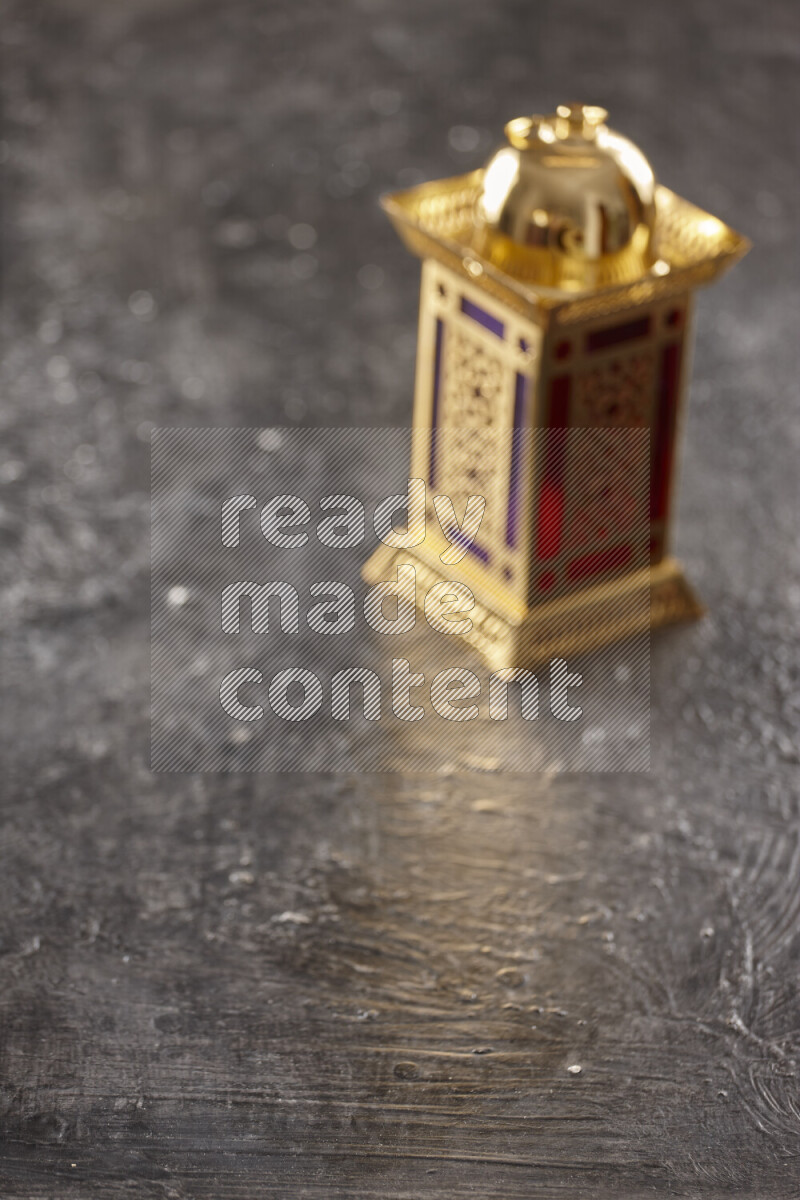 A lantern placed on a textured black background