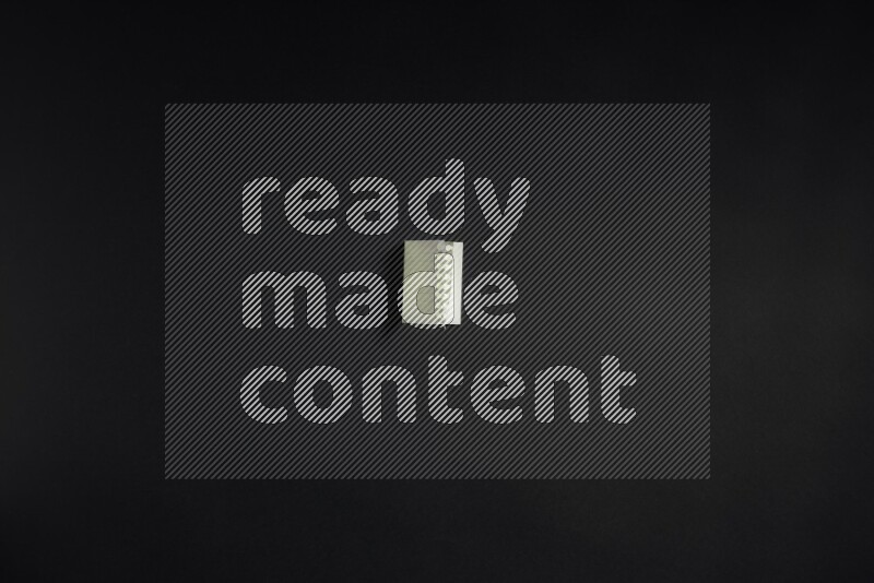 Folded notebook sheet on black background