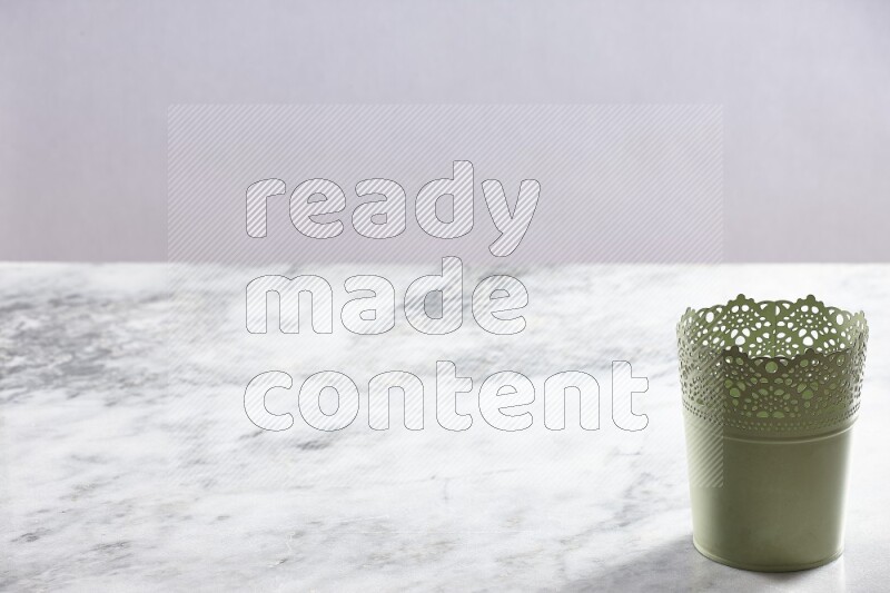 An empty green plant pot on grey marble background