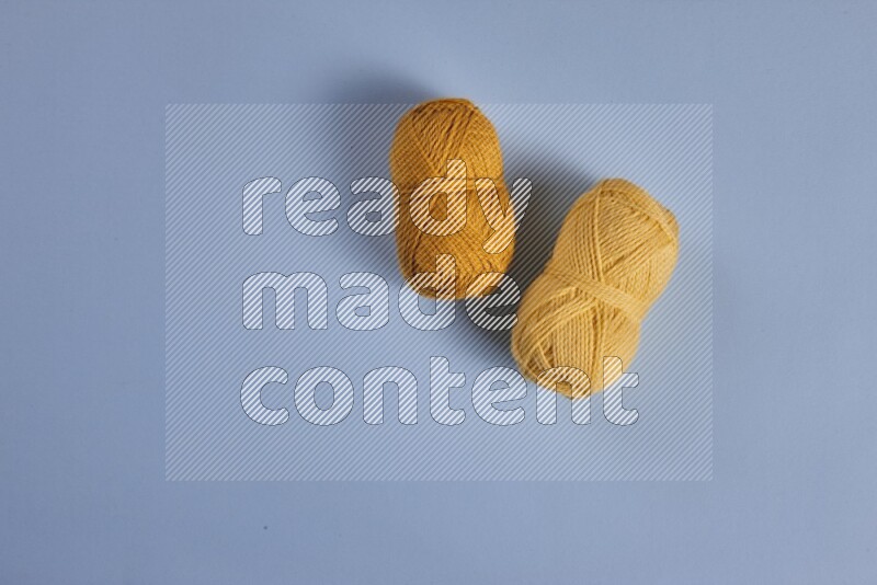 A yellow collection of sewing and tailoring tools arranged on a blue background