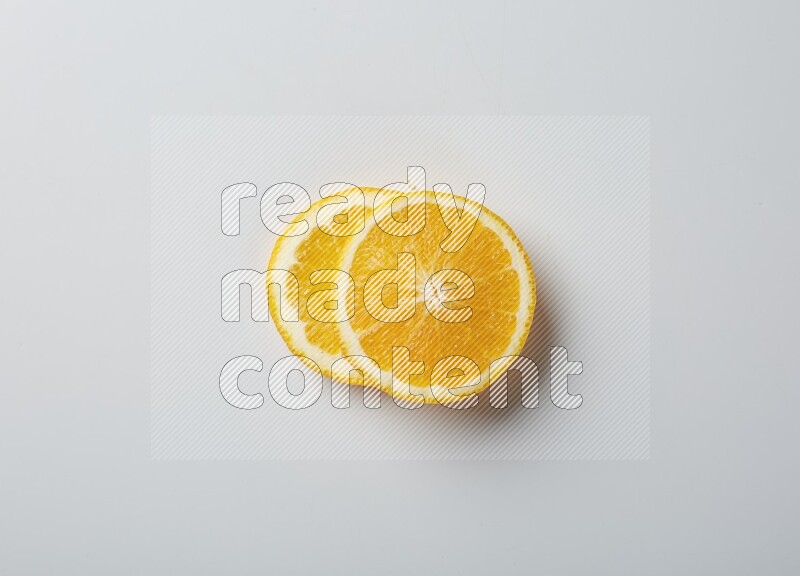 Two orange slices on white background