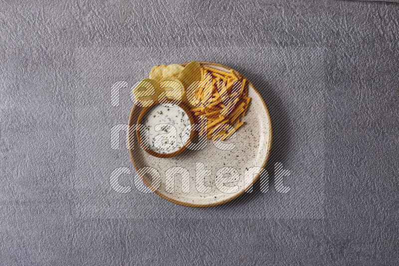 Assorted snacks in pottery bowls on grey background