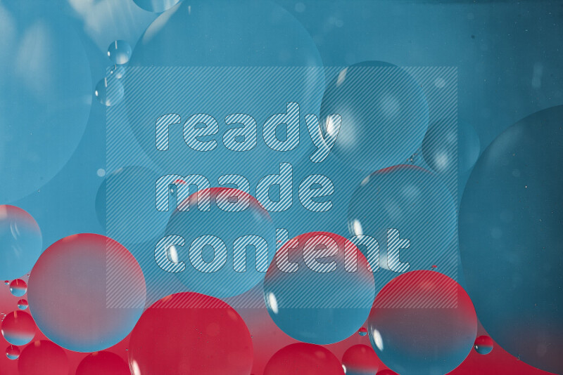 Close-ups of abstract oil bubbles on water surface in shades of blue and pink