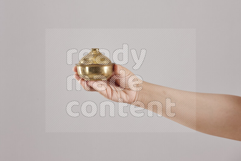 Woman hands holding different metal essentials in different positions