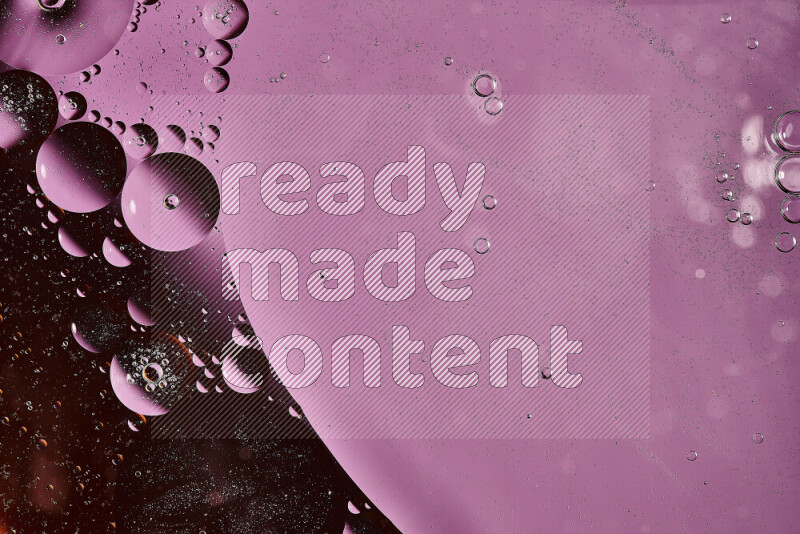 Close-ups of abstract oil bubbles on water surface in shades of orange and purple