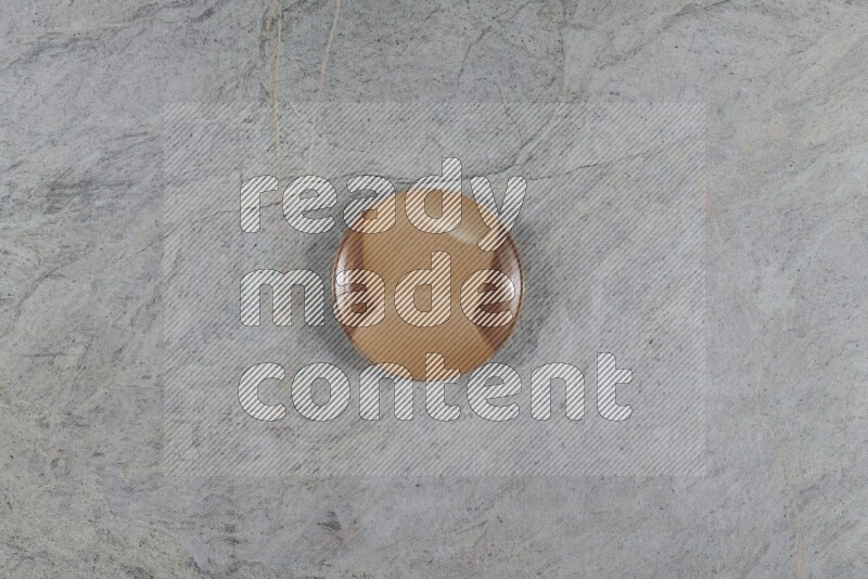 A multicolored pottery plate on grey marble background